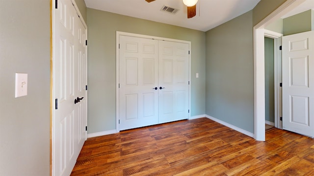 unfurnished bedroom with dark hardwood / wood-style floors and ceiling fan