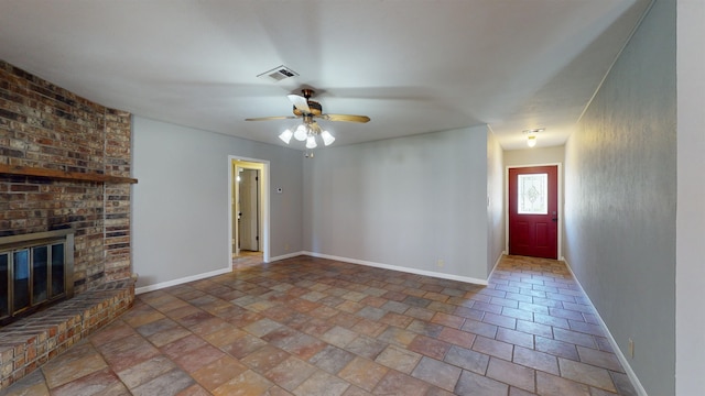 unfurnished living room with a fireplace and ceiling fan