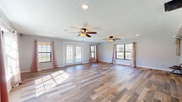 spare room with french doors, a textured ceiling, ceiling fan, and wood-type flooring