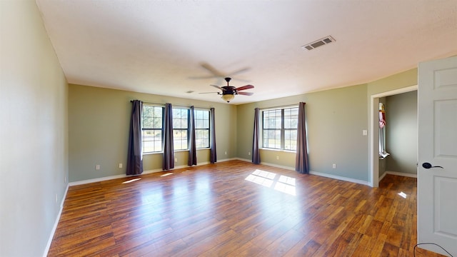 spare room with ceiling fan and dark hardwood / wood-style flooring