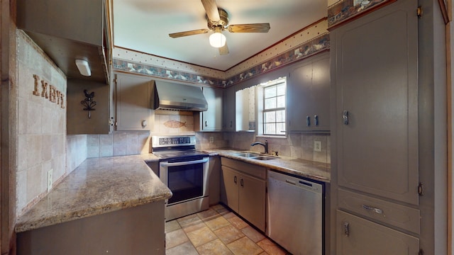 kitchen with decorative backsplash, sink, wall chimney range hood, and appliances with stainless steel finishes