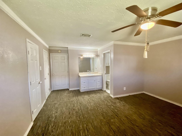 unfurnished bedroom featuring ensuite bathroom, ceiling fan, dark hardwood / wood-style flooring, ornamental molding, and sink