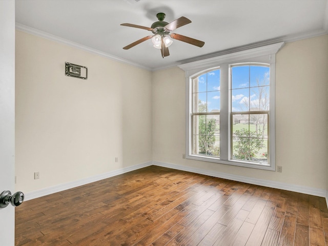 empty room with ornamental molding, dark hardwood / wood-style floors, and ceiling fan