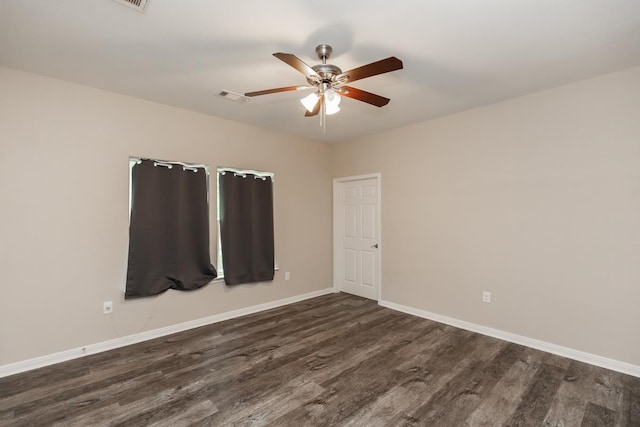 9205 Shepherd Dr, Beaumont, TX 77707 - spare room with dark wood-style flooring, a ceiling fan, and baseboards