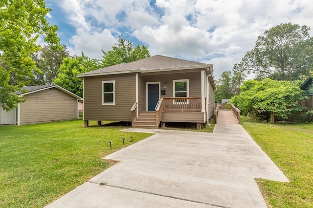 9205 Shepherd Dr, Beaumont, TX 77707 - bungalow-style house featuring a shingled roof, a front yard, and a porch