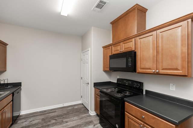 9205 Shepherd Dr, Beaumont, TX 77707 - kitchen with black appliances, dark countertops, dark wood finished floors, and baseboards