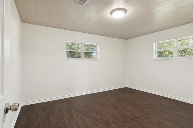 empty room featuring dark wood-type flooring