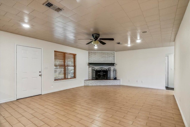 unfurnished living room with ceiling fan, light wood-type flooring, and a brick fireplace