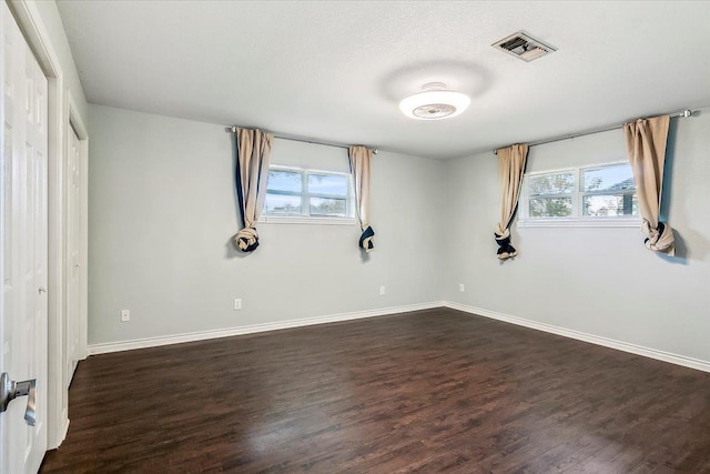 unfurnished bedroom with dark wood-type flooring