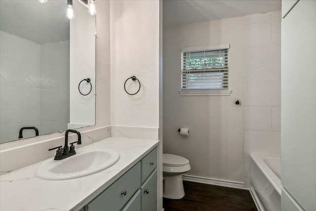 bathroom featuring wood-type flooring, vanity, and toilet