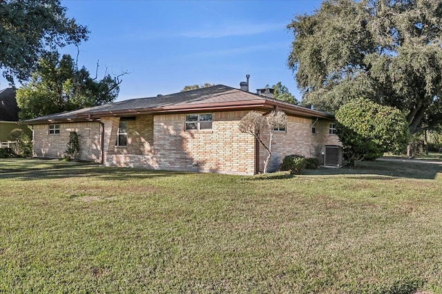 view of home's exterior featuring central air condition unit and a yard