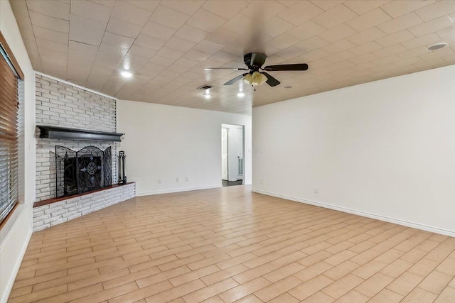 unfurnished living room with ceiling fan, light hardwood / wood-style flooring, and a brick fireplace