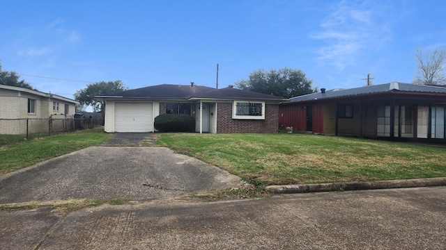 view of front of home with fence, driveway, an attached garage, a front lawn, and brick siding