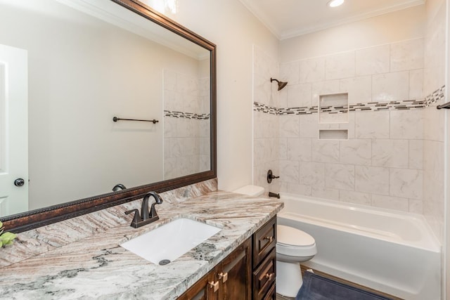 full bathroom featuring vanity, tiled shower / bath, ornamental molding, and toilet