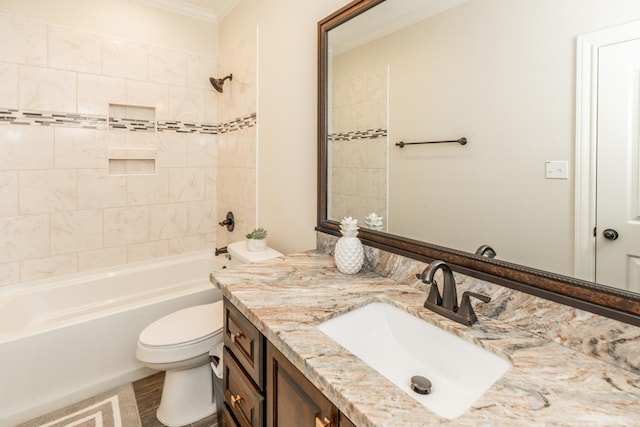 full bathroom with vanity, tiled shower / bath, crown molding, hardwood / wood-style flooring, and toilet