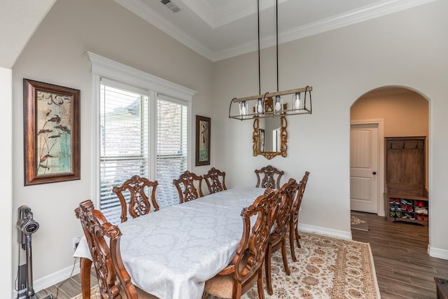 dining space with dark hardwood / wood-style floors and crown molding