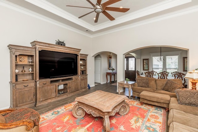 living room with ceiling fan, dark hardwood / wood-style floors, and crown molding