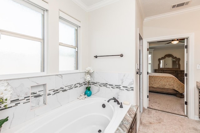 bathroom with tiled tub and crown molding