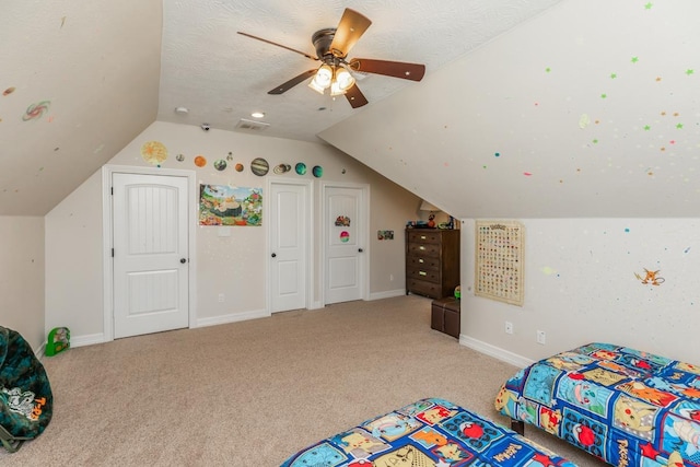 bedroom with light carpet, a textured ceiling, and ceiling fan