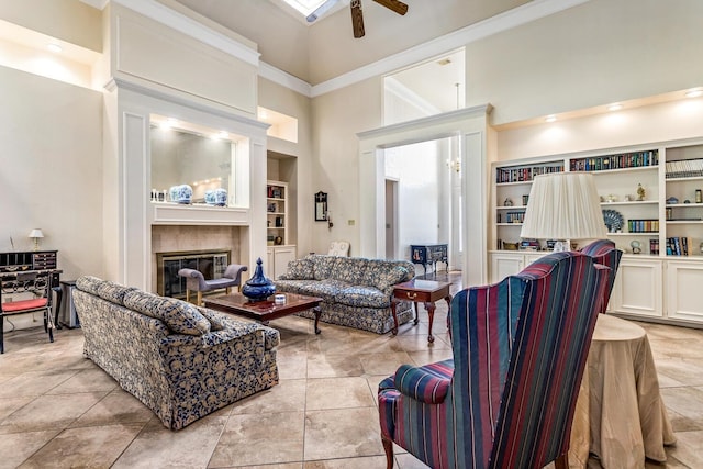 living room with ceiling fan, light tile patterned floors, built in features, and a high ceiling