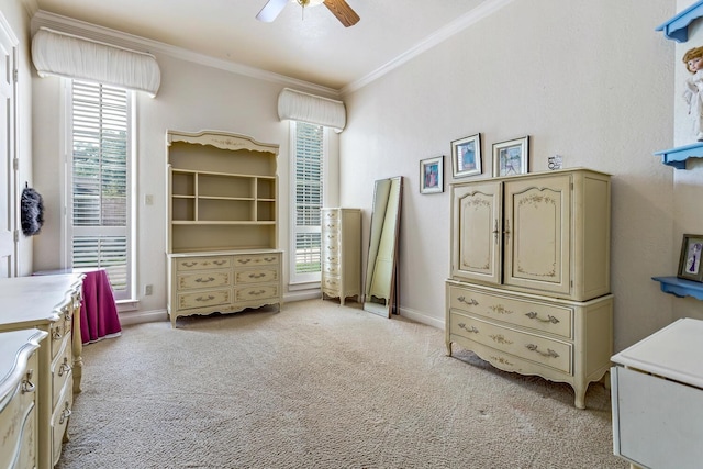 bedroom with ceiling fan, crown molding, light carpet, and a spacious closet