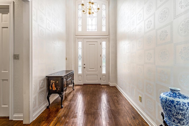 entryway with a chandelier and dark hardwood / wood-style flooring