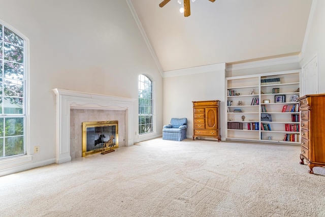 living room featuring a fireplace, carpet flooring, high vaulted ceiling, and ceiling fan