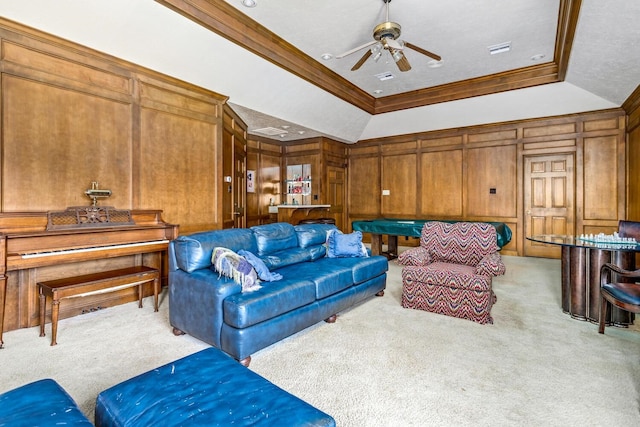 living room featuring a raised ceiling, light carpet, and ornamental molding