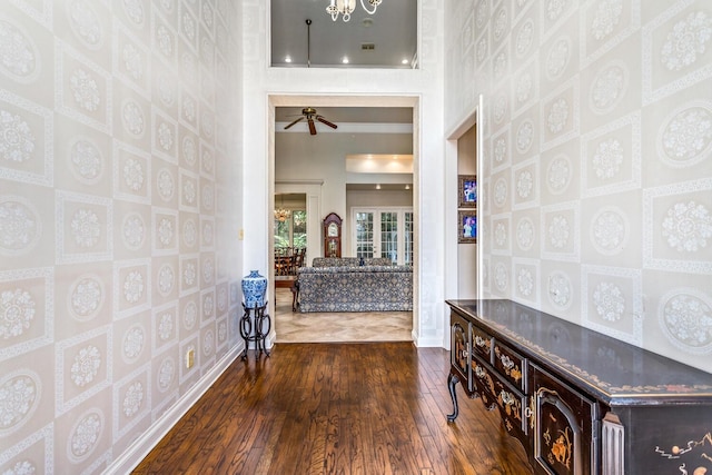 interior space featuring dark hardwood / wood-style flooring and a towering ceiling