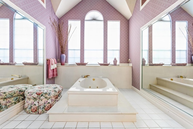 bathroom with a healthy amount of sunlight, a tub, and a high ceiling