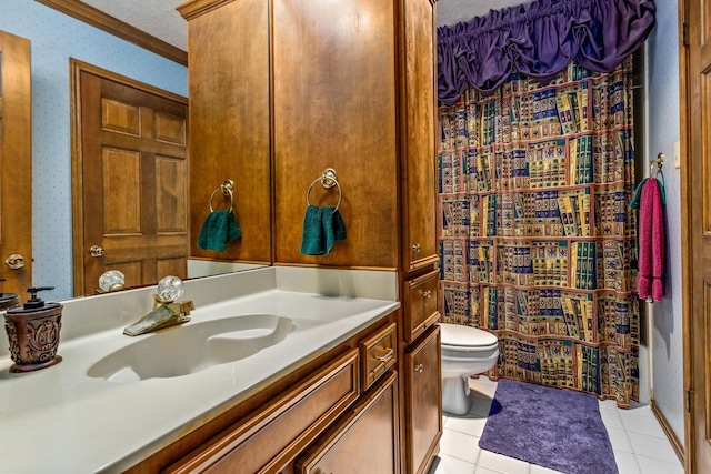 bathroom with vanity, tile patterned flooring, toilet, ornamental molding, and a textured ceiling