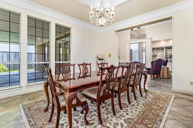 dining area featuring ornamental molding and a notable chandelier