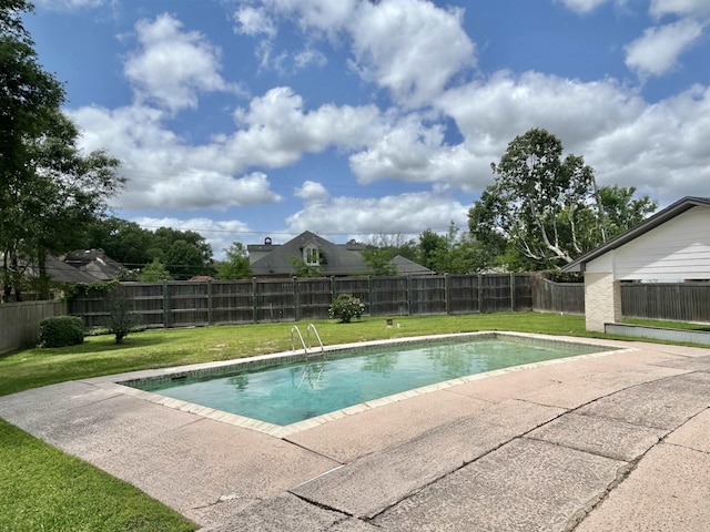 view of swimming pool featuring a yard and a patio