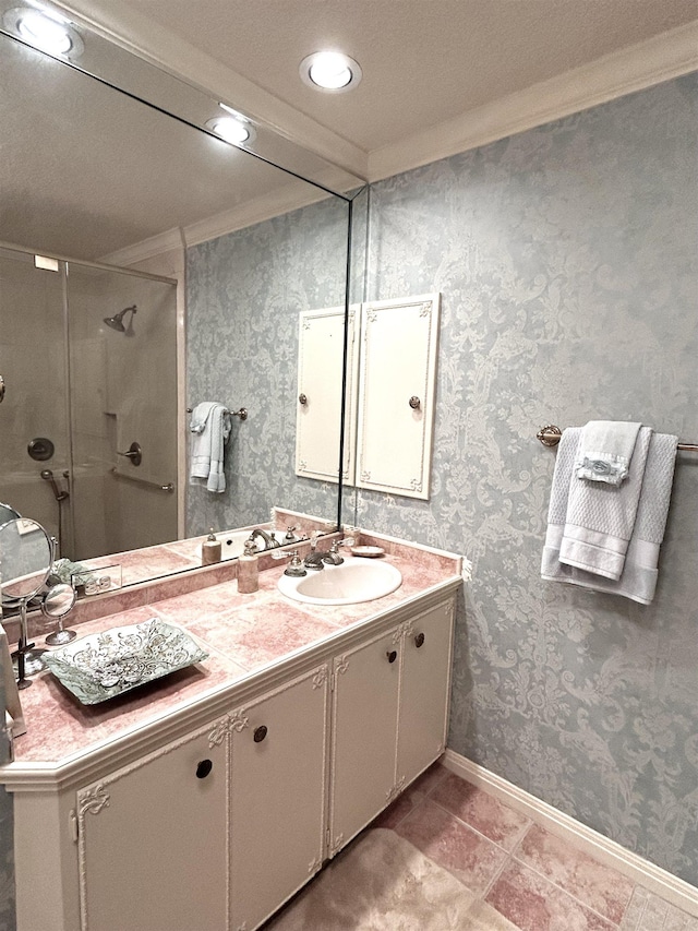 bathroom featuring vanity, a shower with shower door, and ornamental molding