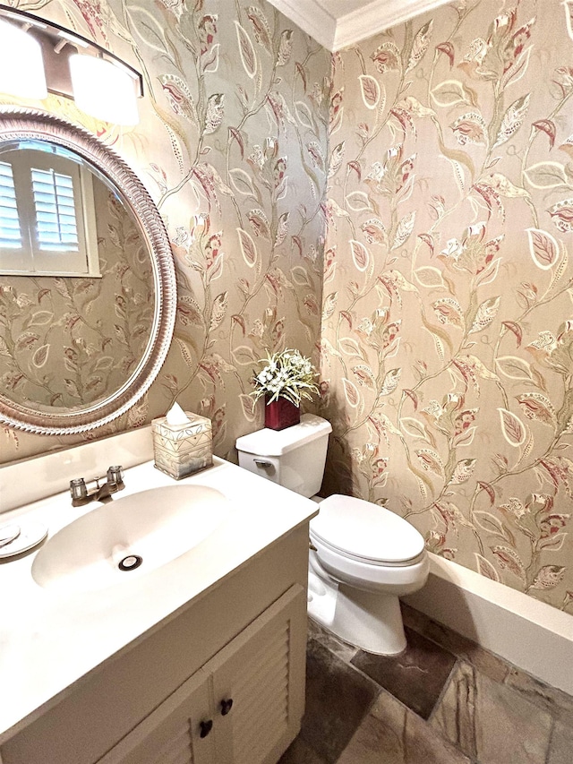 bathroom featuring vanity, toilet, and crown molding