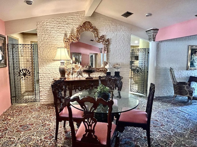 dining space featuring vaulted ceiling with beams