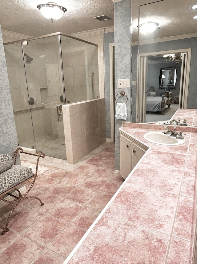 bathroom featuring vanity, a textured ceiling, and a shower with door