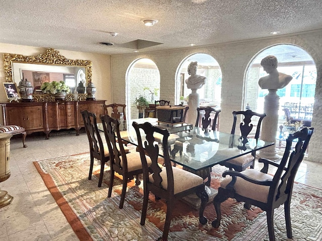 dining area featuring a textured ceiling