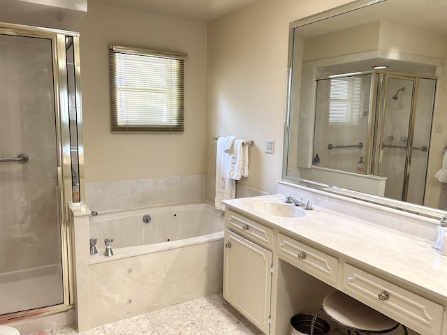 bathroom with vanity and shower with separate bathtub