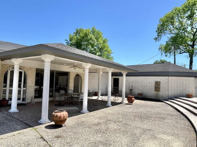 back of property with ceiling fan and a patio area