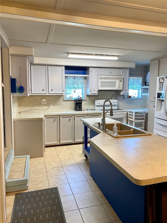 1228 Bahama Ln, Port Bolivar, TX 77650 - kitchen with white appliances, decorative backsplash, light countertops, light tile patterned flooring, and a kitchen island with sink