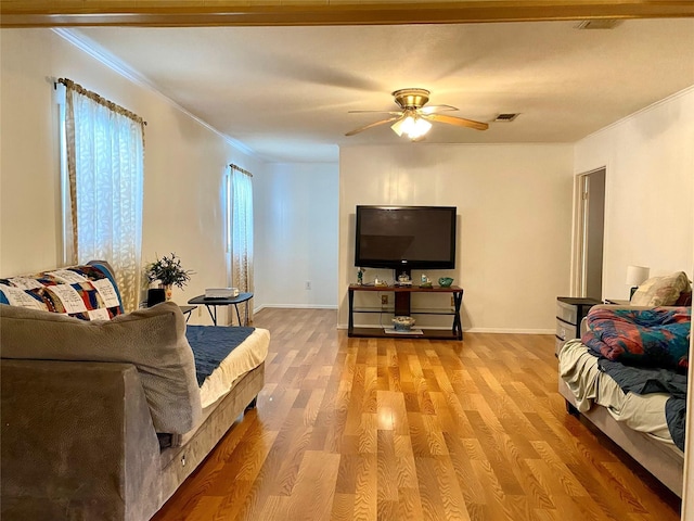 1228 Bahama Ln, Port Bolivar, TX 77650 - living room featuring crown molding, a ceiling fan, light wood-type flooring, and baseboards