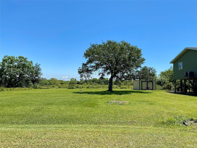 1228 Bahama Ln, Port Bolivar, TX 77650 - view of green lawn with a storage unit and an outbuilding