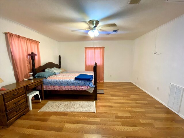 1228 Bahama Ln, Port Bolivar, TX 77650 - bedroom featuring light wood-type flooring, ceiling fan, and baseboards
