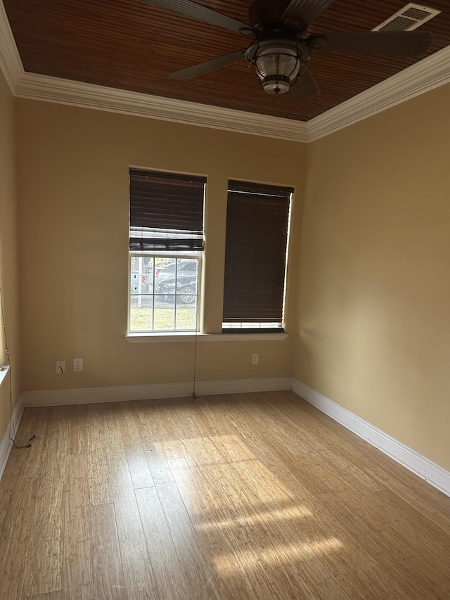 empty room featuring ceiling fan, ornamental molding, light hardwood / wood-style floors, and wooden ceiling