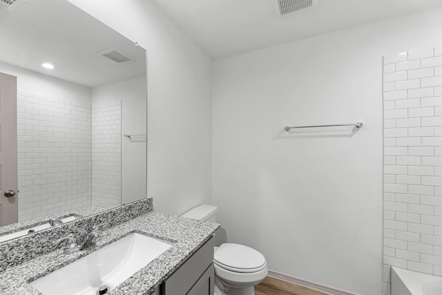 bathroom with recessed lighting, toilet, visible vents, vanity, and wood finished floors
