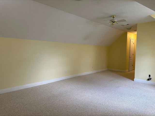 bonus room featuring ceiling fan, light colored carpet, and lofted ceiling