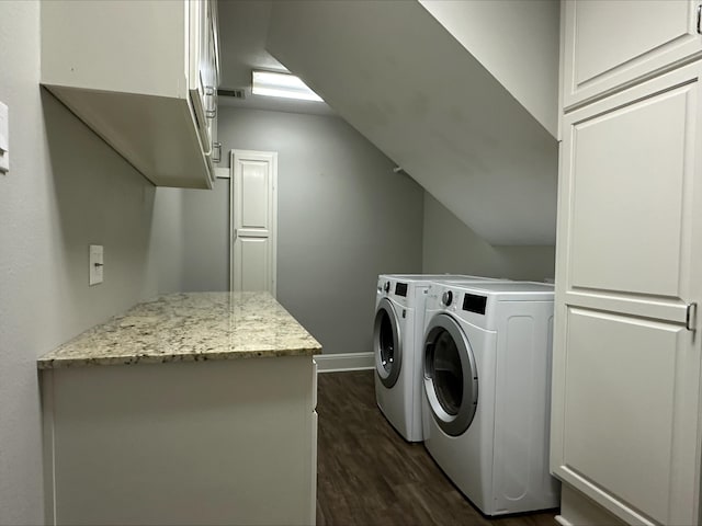 washroom with washing machine and clothes dryer and dark hardwood / wood-style floors