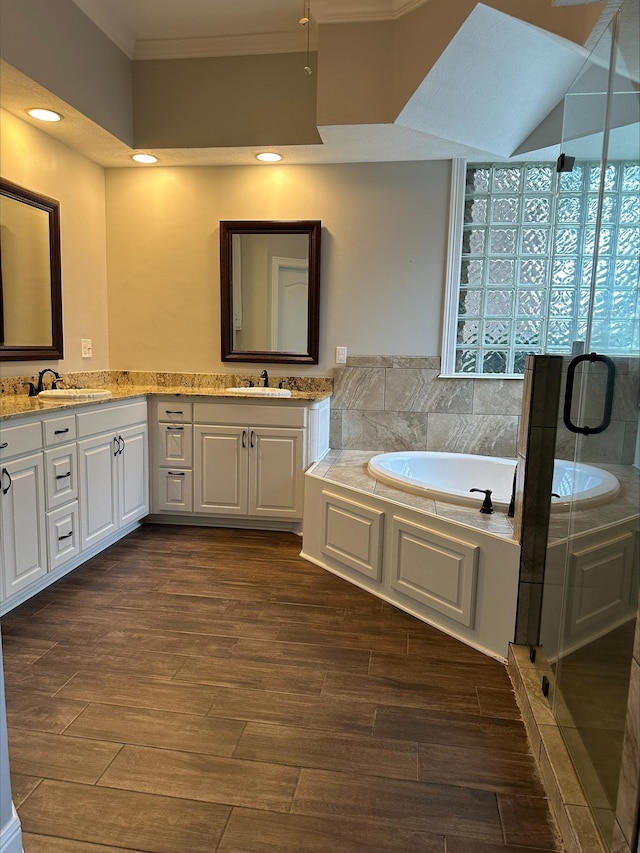 bathroom with vanity, ornamental molding, and independent shower and bath