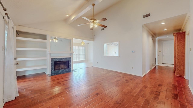 1995 Sams Way, Beaumont, TX 77706 - unfurnished living room featuring wood finished floors, ceiling fan, a high end fireplace, beamed ceiling, and baseboards